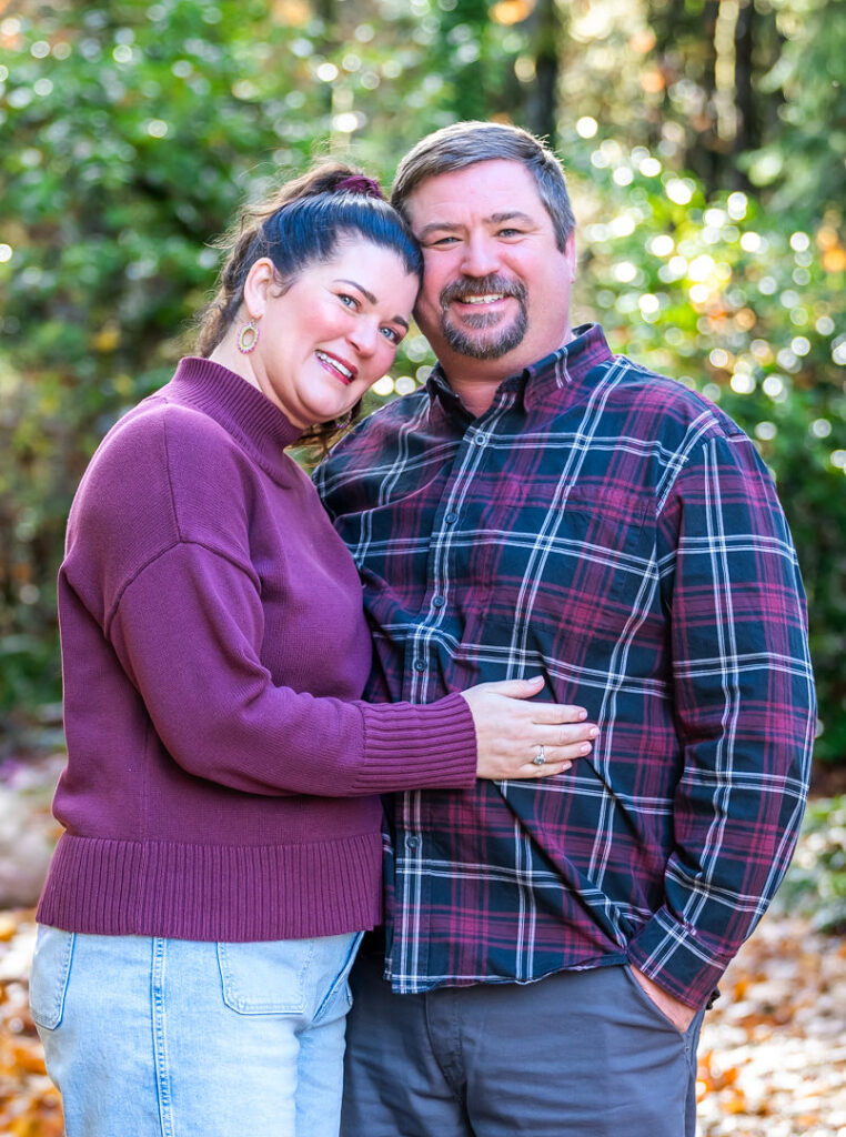 Kitsap County family photographer portrait of a couple embracing cheek to cheek in autumn
