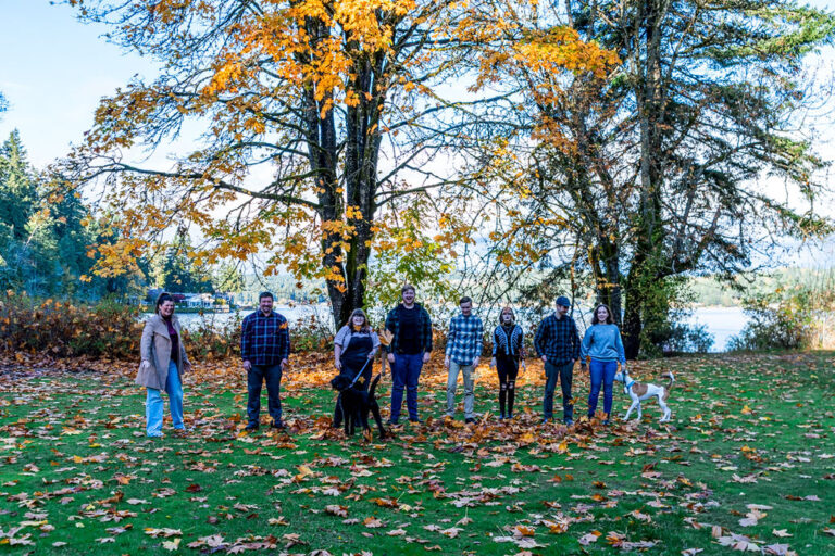 Large extended family beneath autumn trees at a Kitsap County park