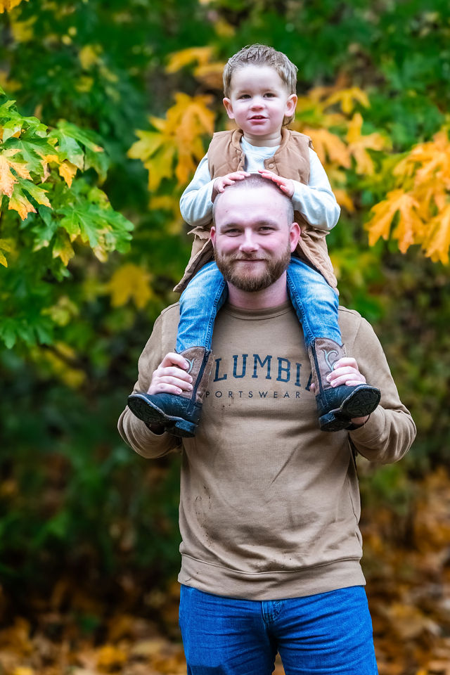 Father carrying his toddler on his shoulders during a fall family photo session in Kitsap County, Washington