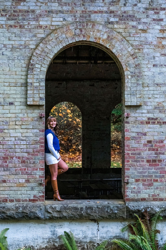 Senior Portrait with brick building at Manchester state park