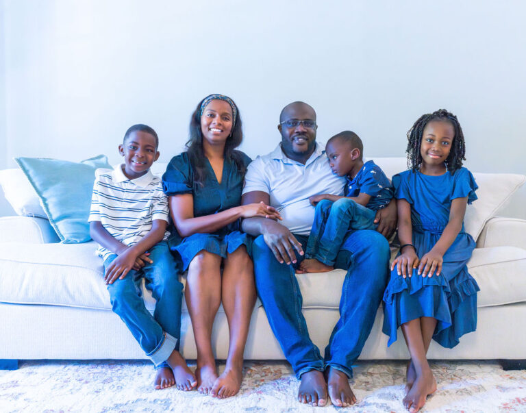 Family enjoying their photos at home, album versus wall art versus digital guide