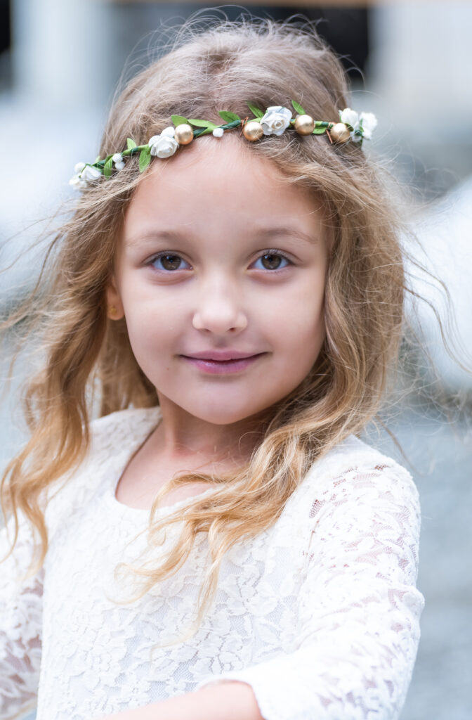 Portrait of a young girl at a Buckley Washington wedding wearing white.
