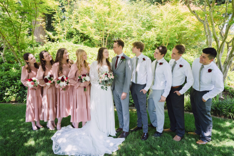 Bridal party gathered together looking at the bride and groom during a Kitsap wedding