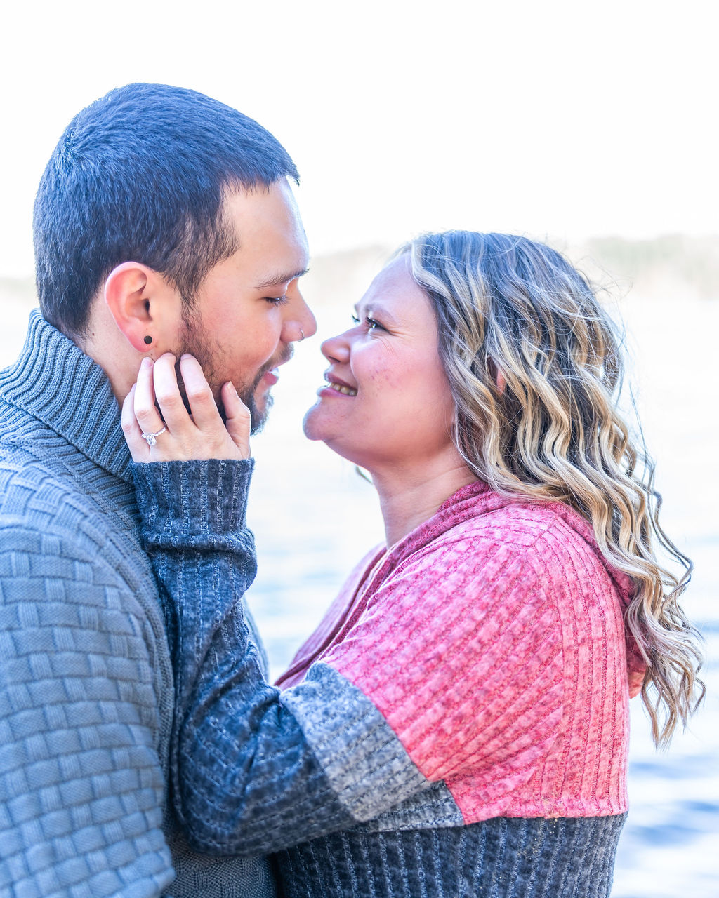 Newly engaged couple in the moments after a surprise proposal at Manchester State Park in Kitsap County, Washington
