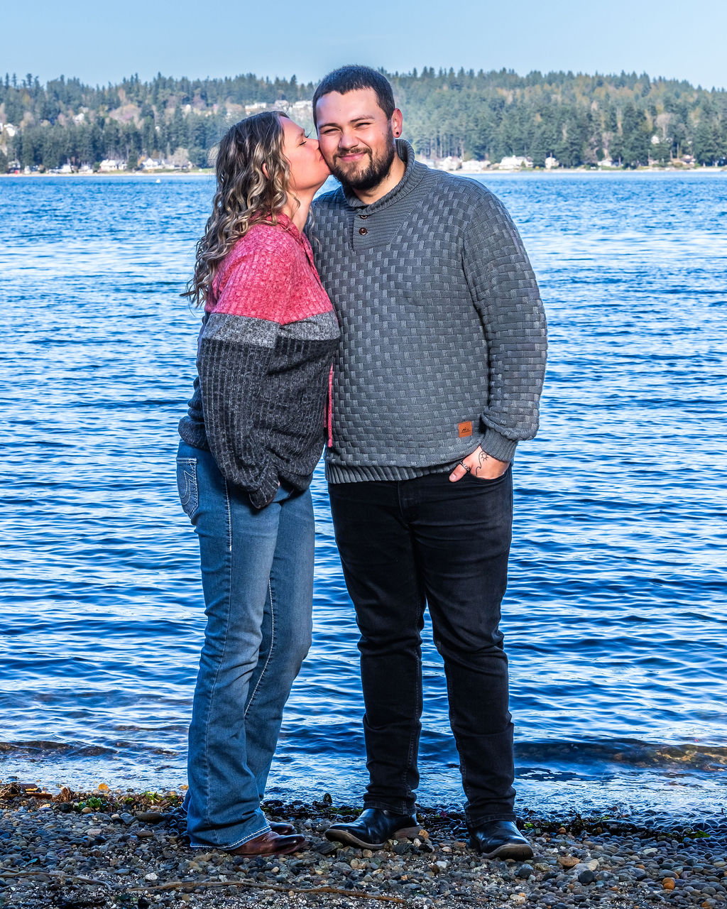 Newly engaged couple kissing during proposal photography at Manchester State Park in Kitsap County, Washington