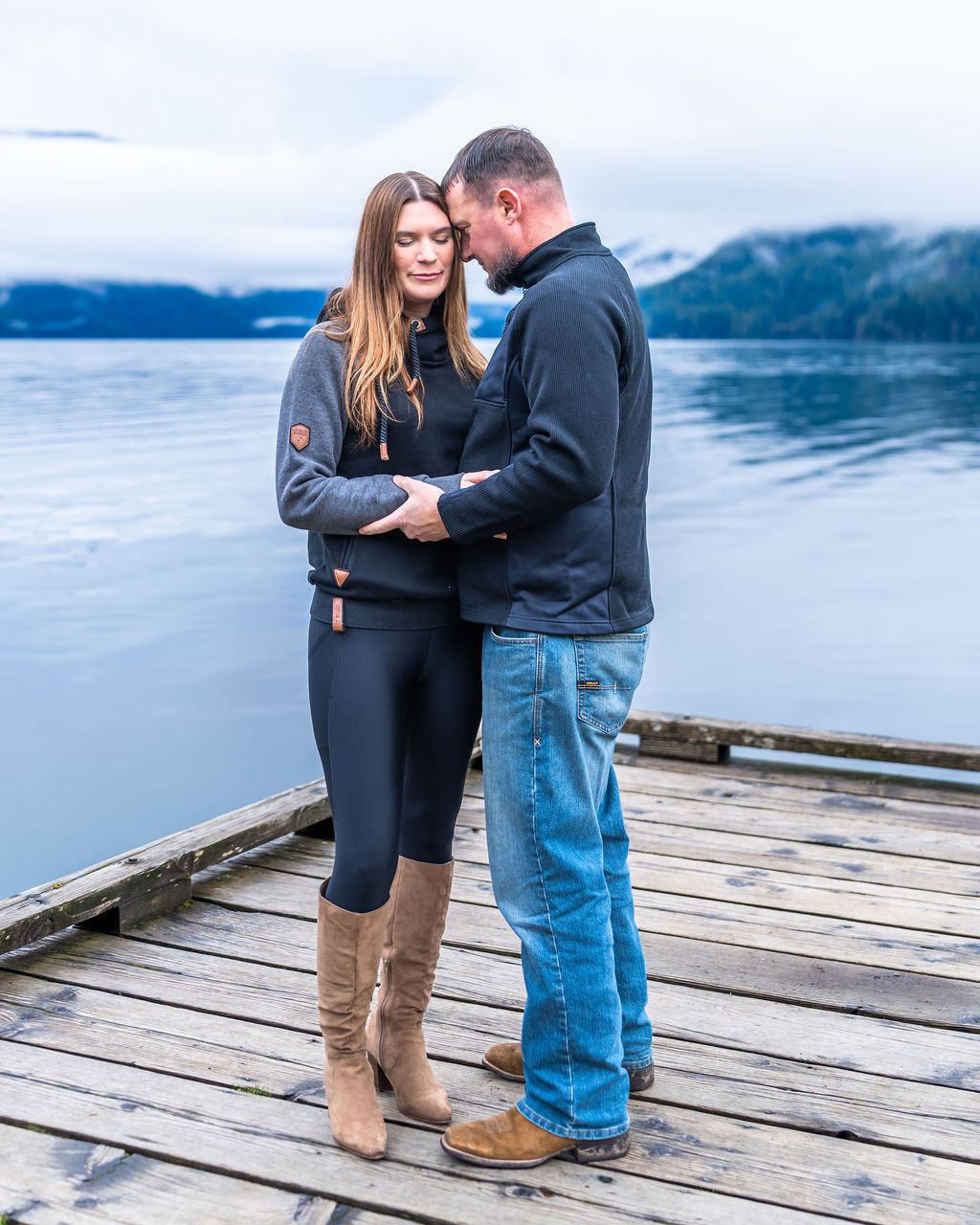 Engagement session portrait of a couple on the dock at Lake Crescent in Olympic National Park Washington