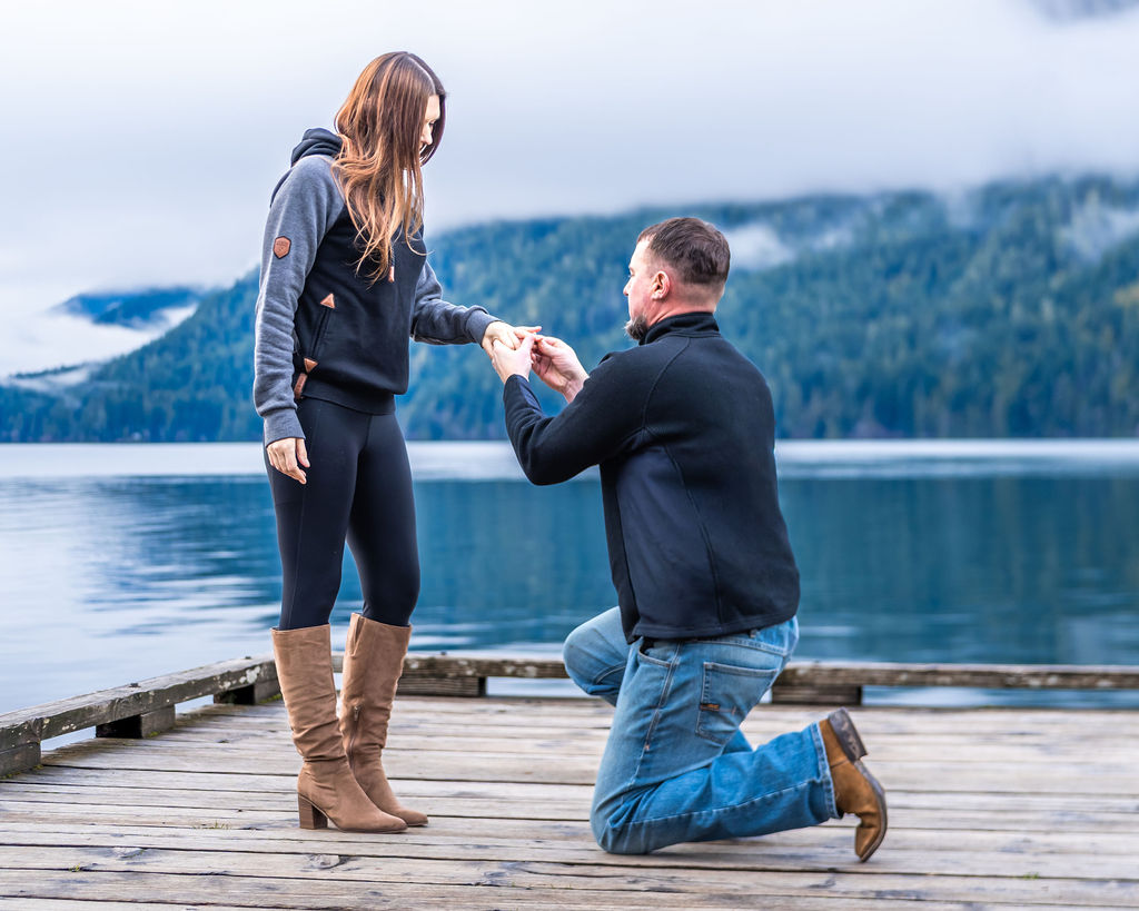 Man proposing during an engagement session on a dock at Lake Crescent in Olympic National Park.