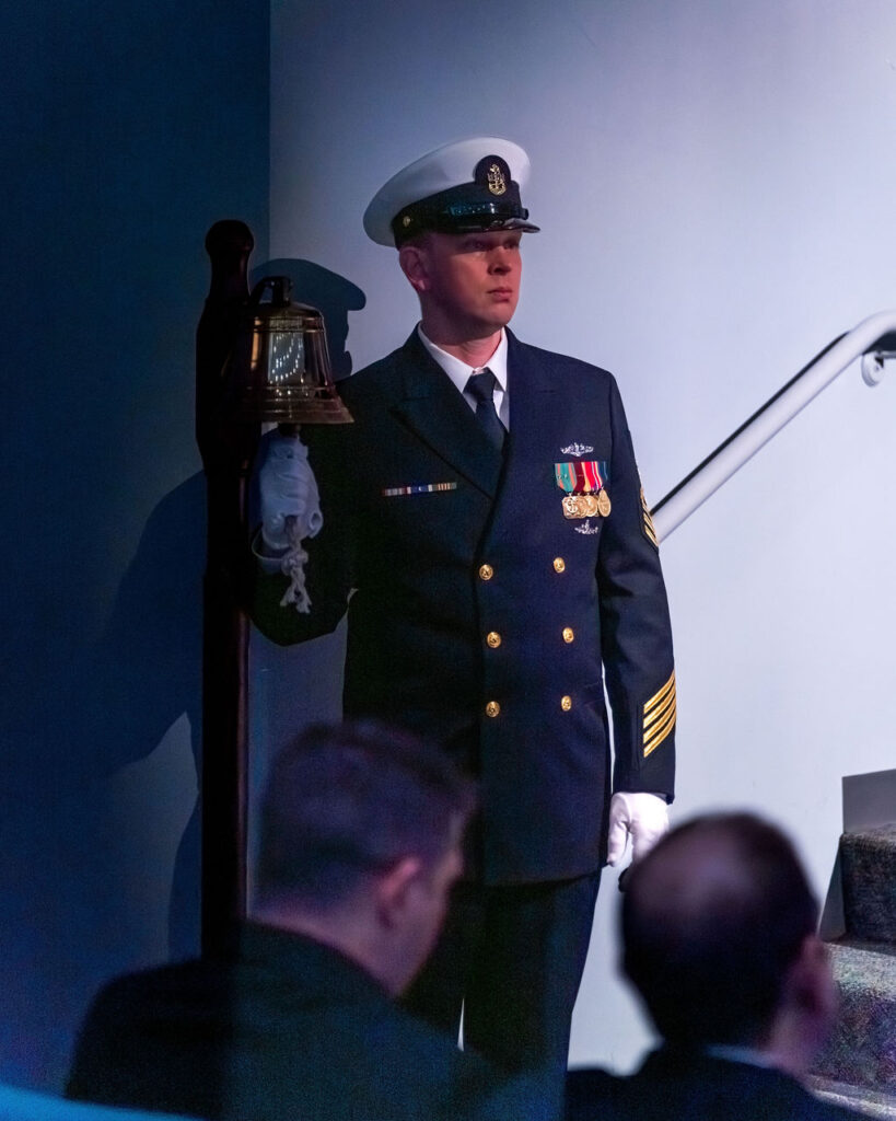 Chief Petty Officer at bell during retirement ceremony