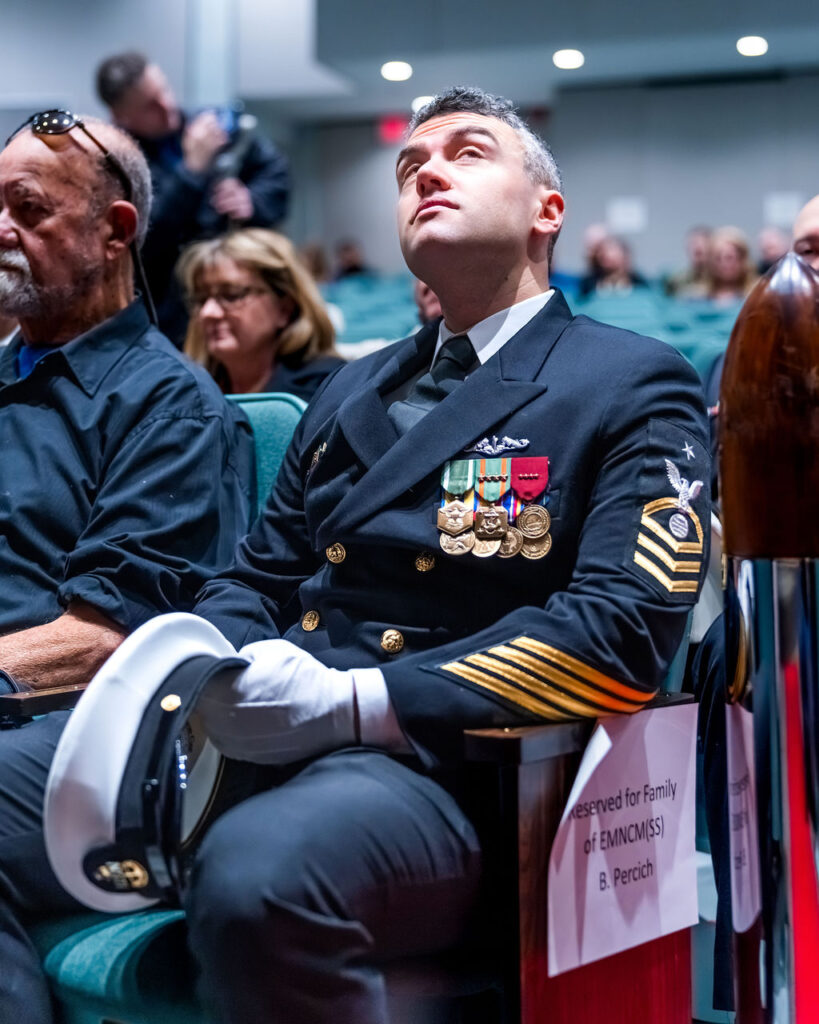 senior Chief looking up well seated at retirement ceremony.