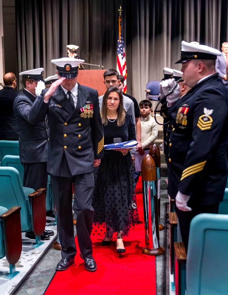 Master Chief exiting with family during ceremony.