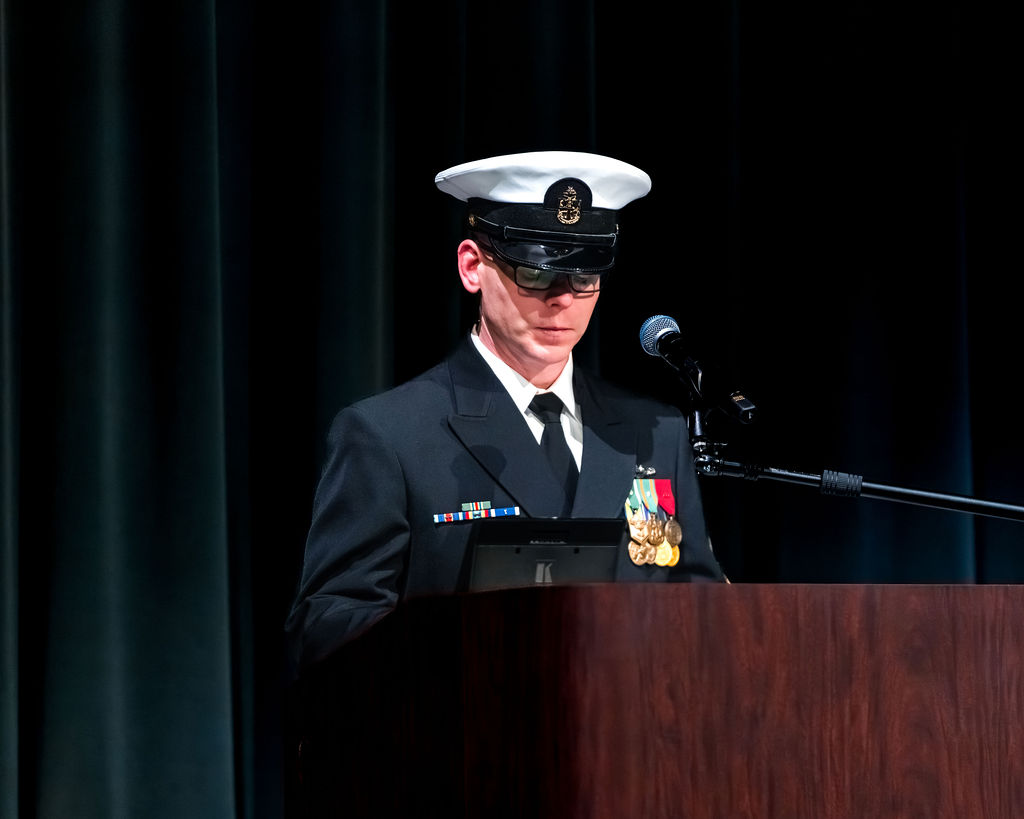 Naval Chief speaking at podium during retirement ceremony.