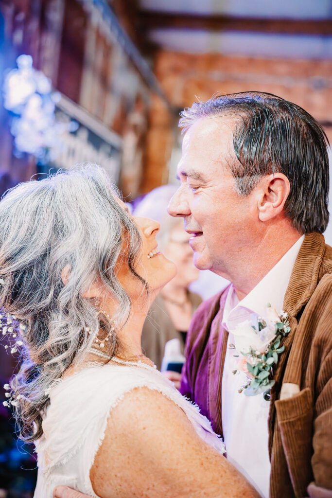 Bride and groom sharing a romantic moment during their wedding at Burley Creek Nursery in Port Orchard Washington photographed by Bremerton wedding photographer