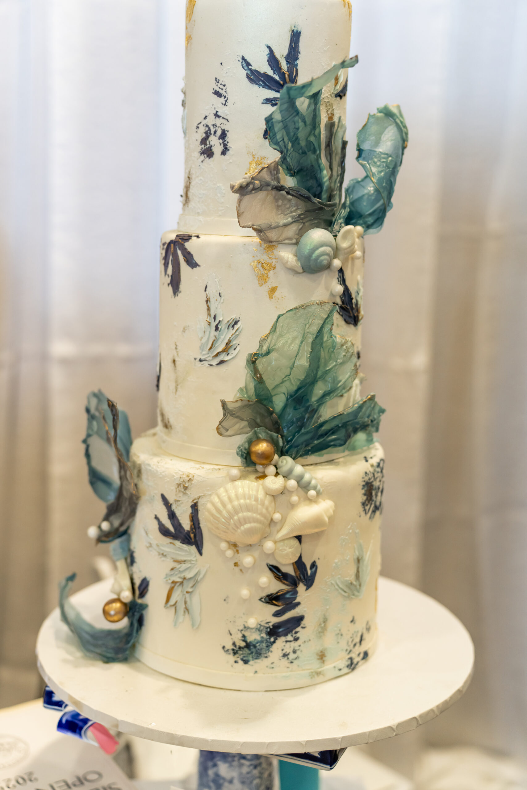 Ocean themed tiered wedding cake with seashells and pearls from a Kitsap or Gig Harbor bakery