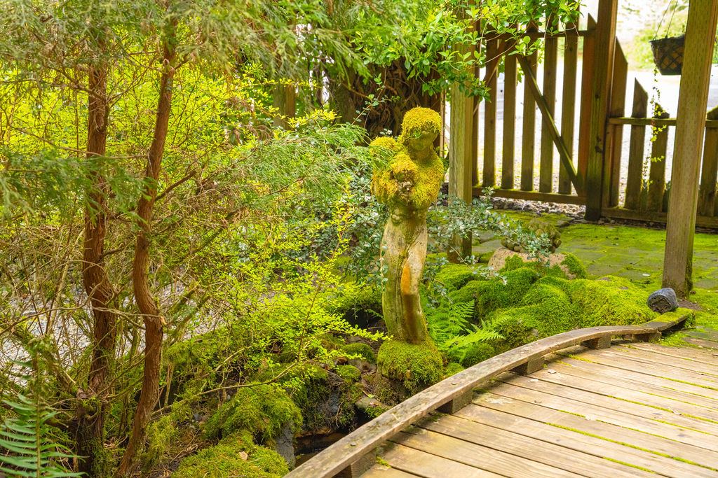 garden statue and moss covered bridge at olalla vineyard wedding venue in kitsap county
