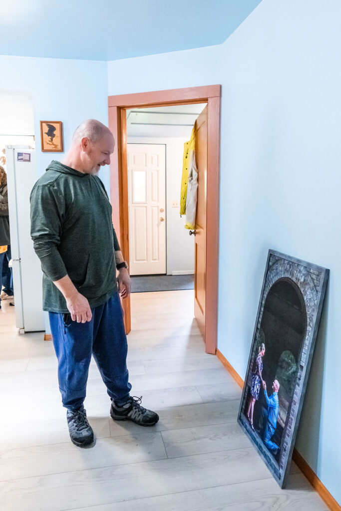 Groom looking at a framed engagement photo from Nautical Moments Photography on his wedding day in Washington