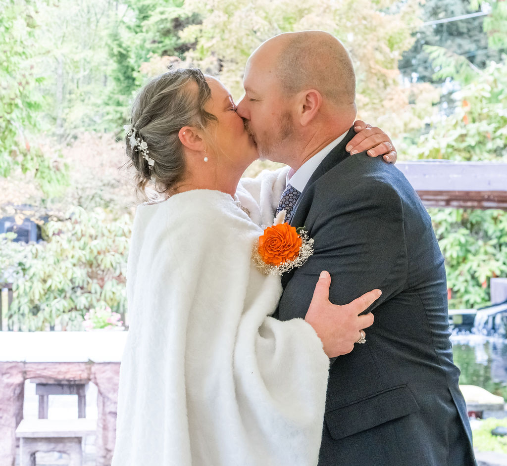 Bride and groom kissing after exchanging vows during an outdoor wedding ceremony on Vashon Island, Washington