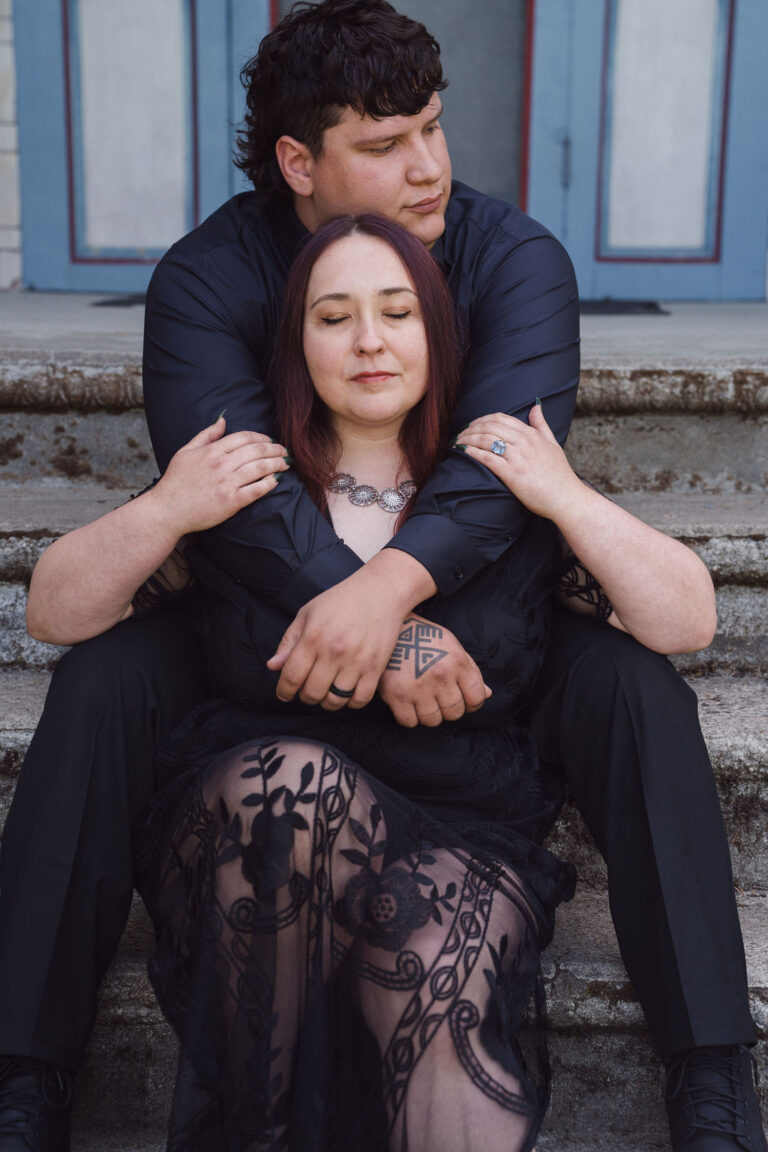 Engaged couple on the historic house steps at Scenic Beach State Park in Kitsap County