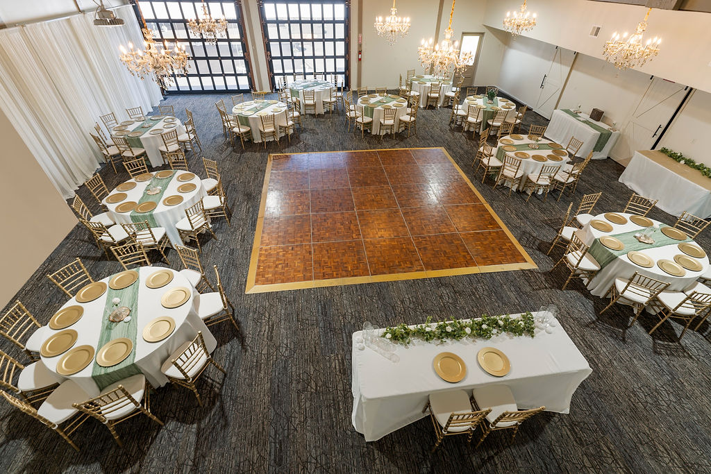 Elegant reception ballroom with chandeliers and round tables at Vickery Gardens wedding venue near Tacoma