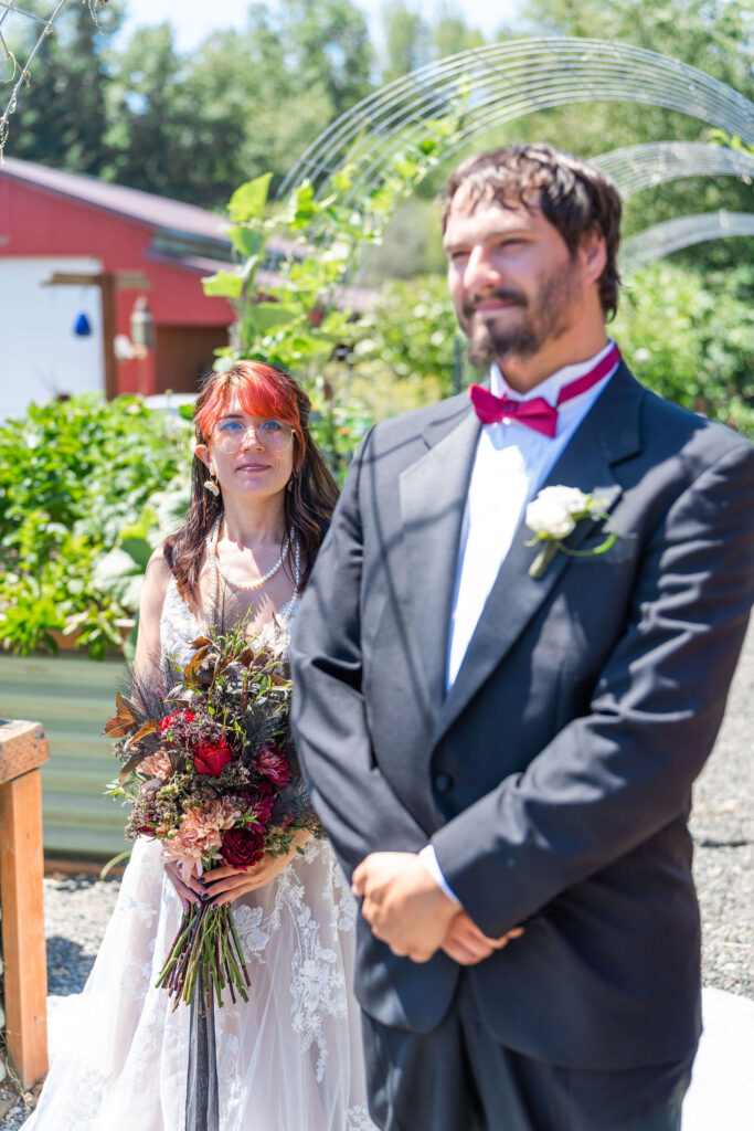 Couple standing together before outdoor ceremony at Vickery Gardens wedding venue