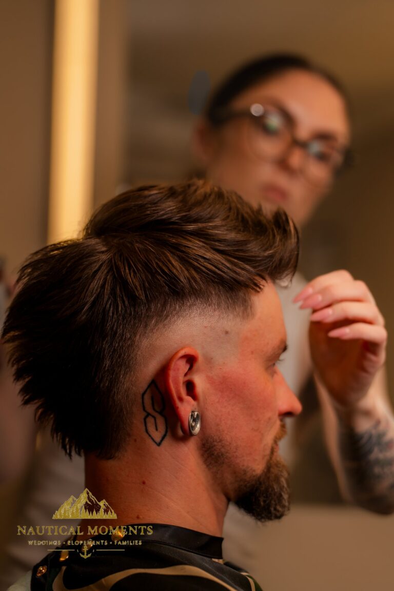 Bremerton barber Kate Wrinkler styling a client's hair with her reflection in the mirror. personal branding photography Kitsap County