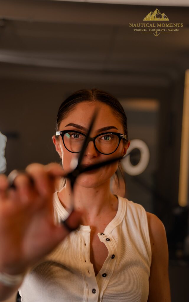 Kate holding scissors confidently in posed portrait 