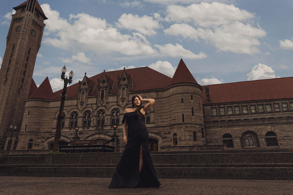Posed portrait of senior in front of a castle.