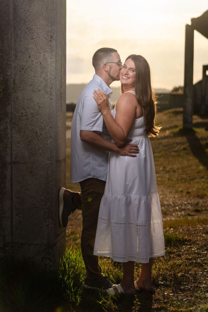 couple holding with woman looking at camera during engagement photoshoot in Tacoma.