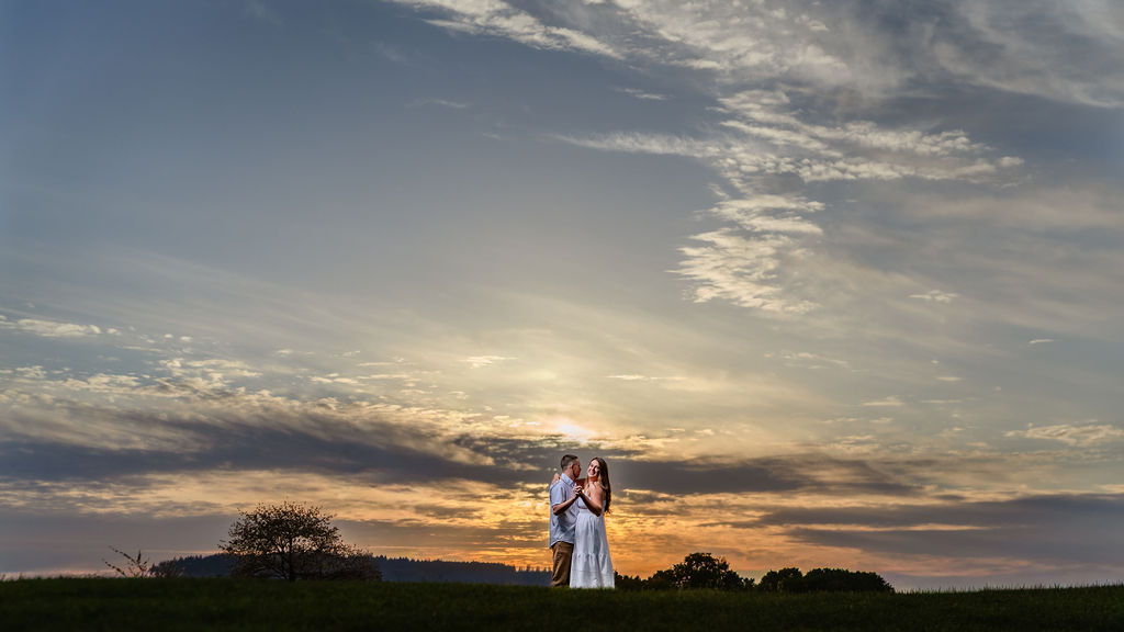 Couple with big Sky Views during engagement at chambers bay trails.