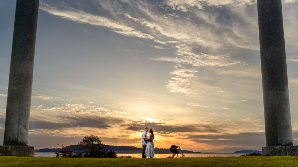 Bid sky with pillars and couple during sunset engagement photoshoot in tacoma.