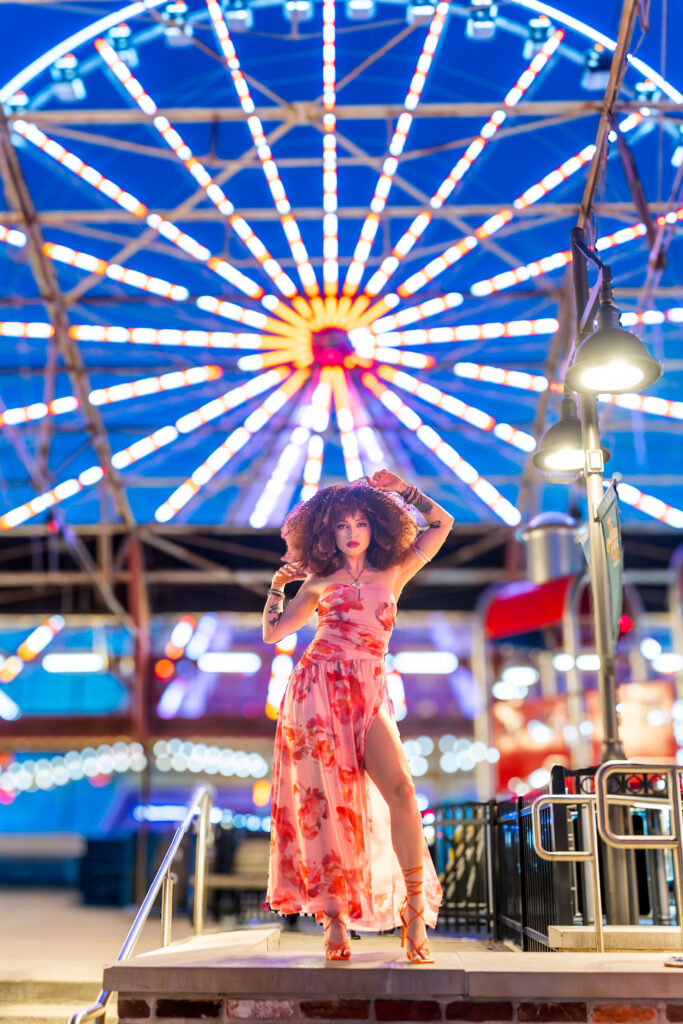 Female with Ferris while in background posing confidently