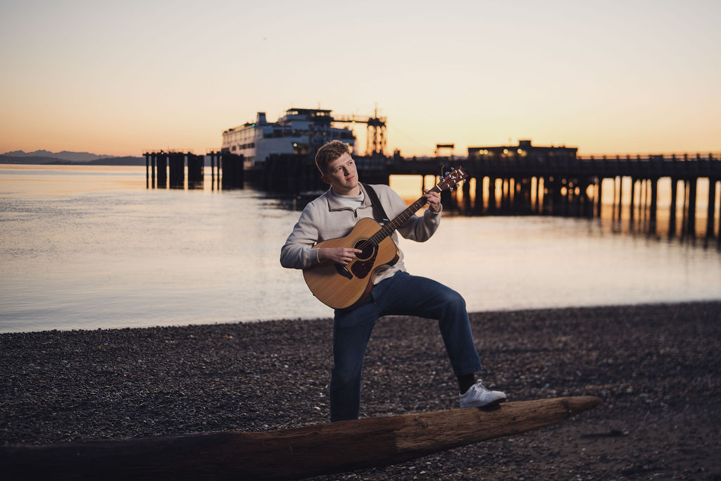 Zach playing guitar during photoshoot.