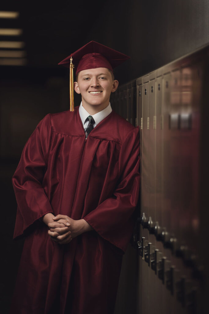 Zach next to lockers with reflection.