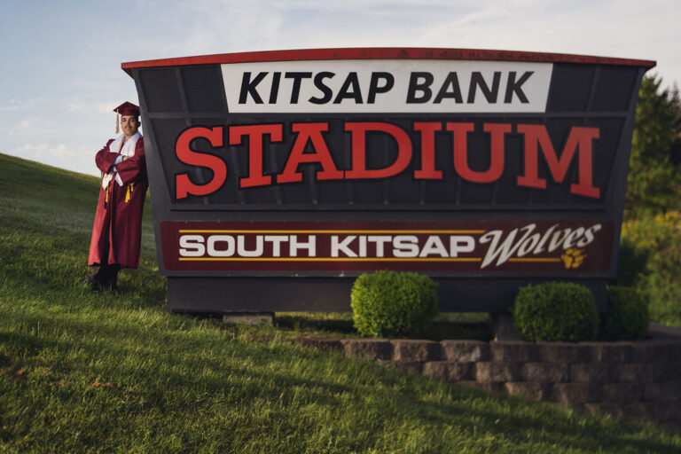 South Kitsap High School senior beside the school sign during a Kitsap County senior session