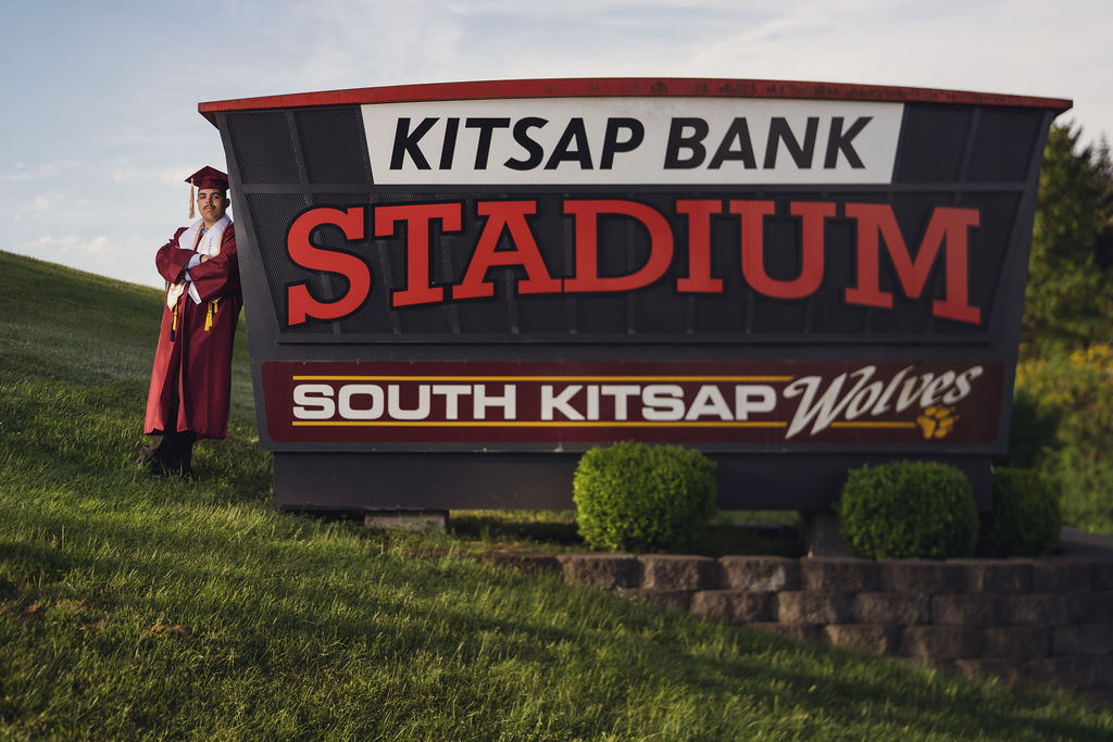 South Kitsap High school Senior near souths sign.