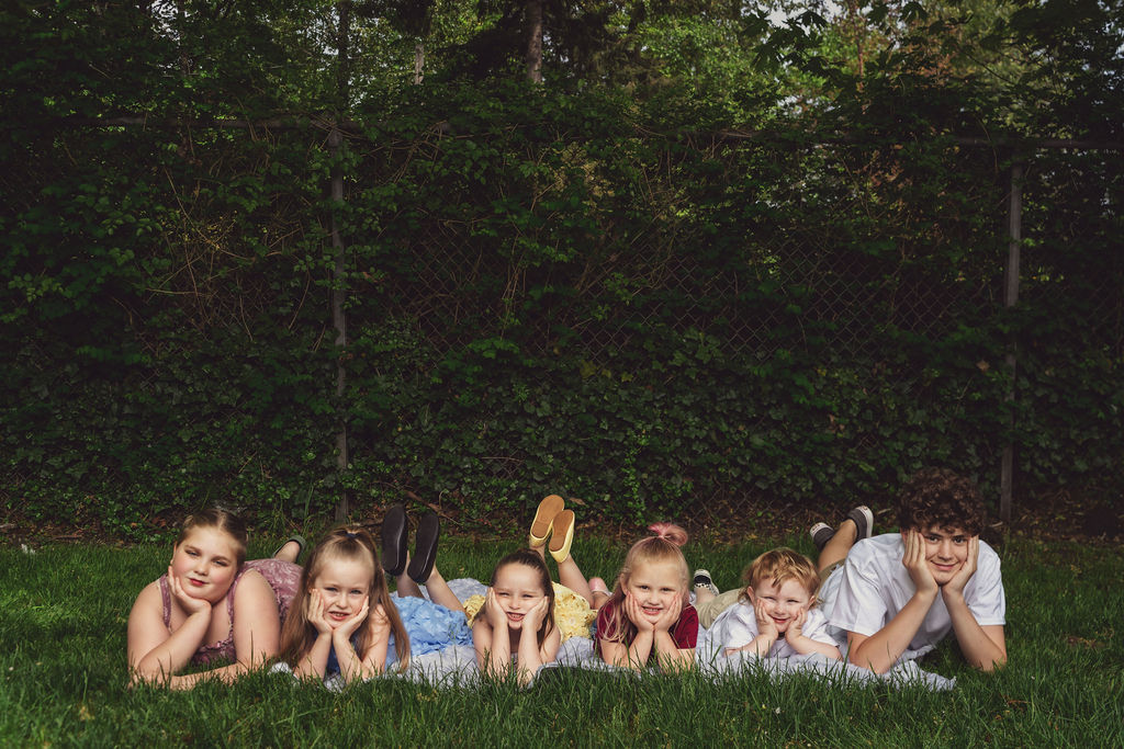 Children lying in the grass propped on their hands at a Kitsap County park