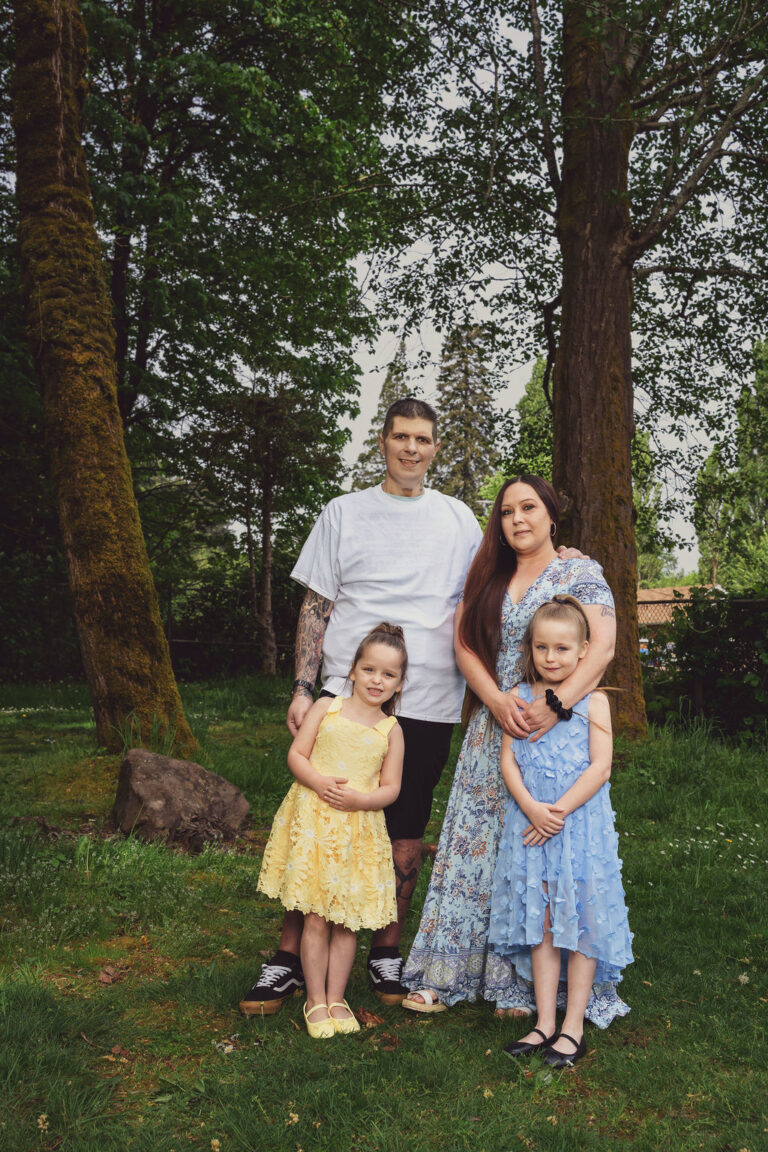 Family with two daughters among the trees in Kitsap County