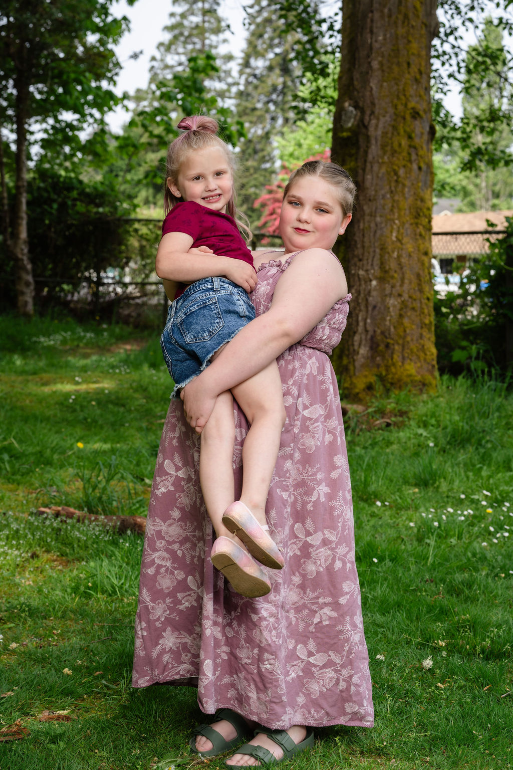 Two sisters posing together at a Kitsap County park