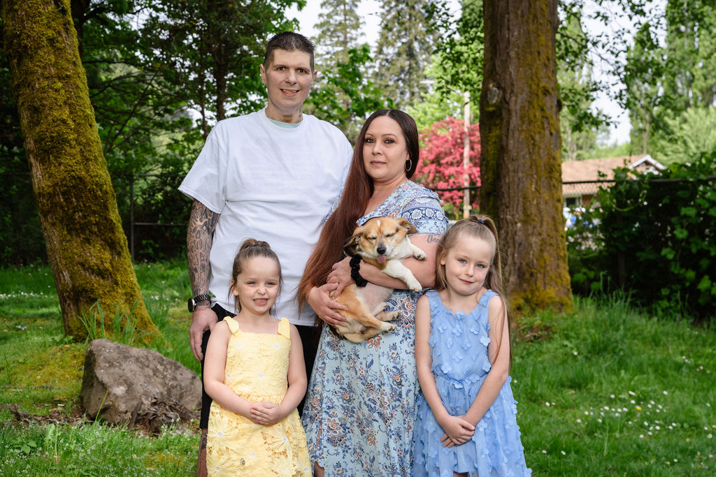 Family with two daughters and their dog at a green Kitsap County park