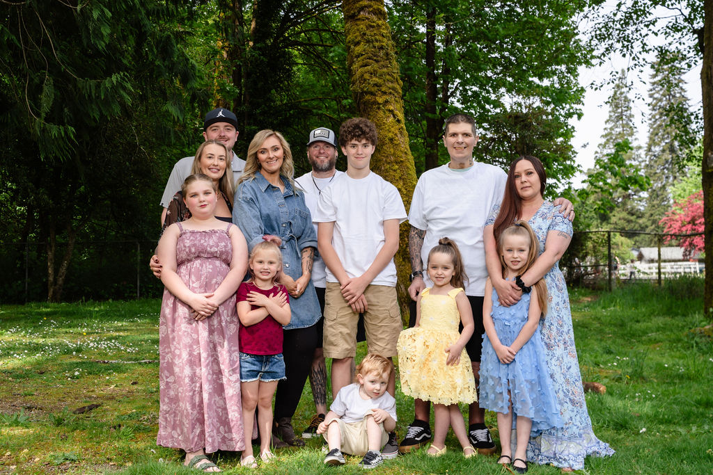 Large extended family gathered together at a green Kitsap County park