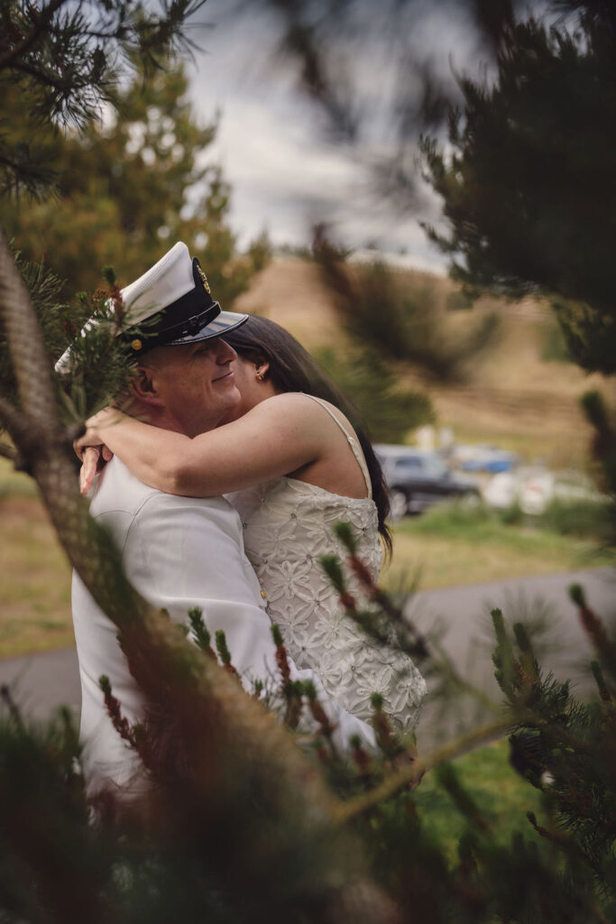 Couple embracing at golden hour at Chambers Bay in Tacoma Washington