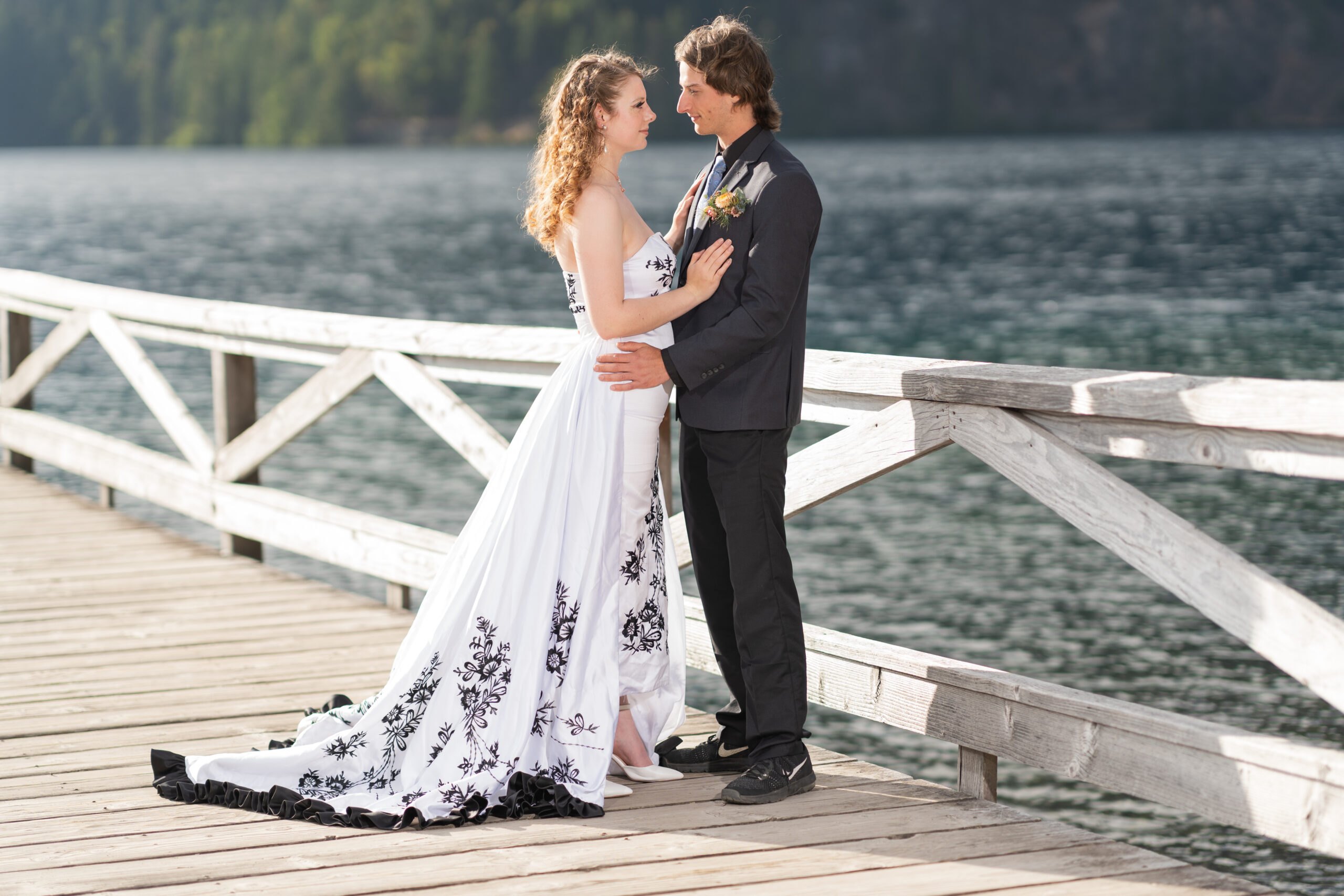 Bride and groom during wedding portraits on a wooden dock over the water in Washington