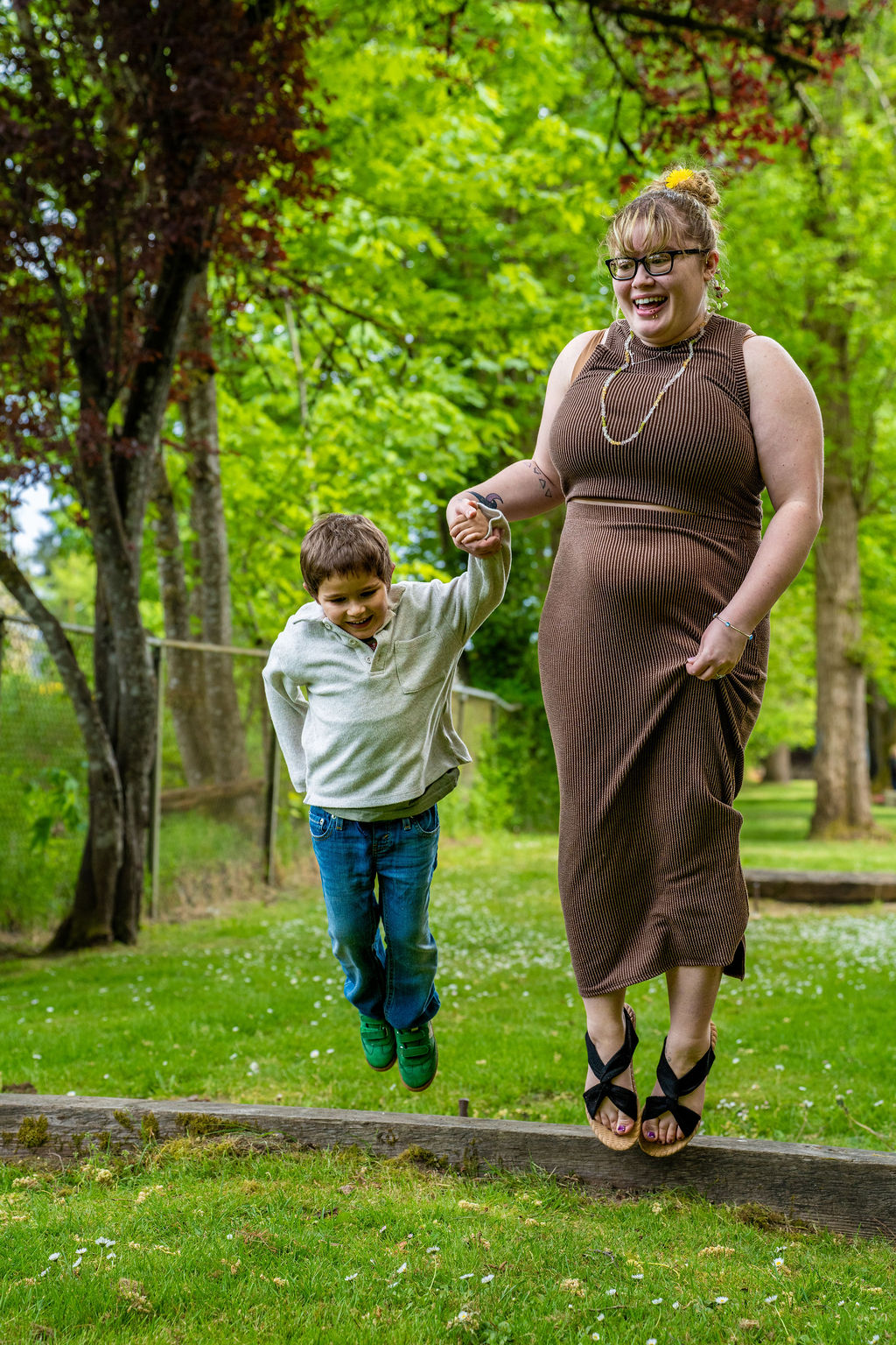 Family photo session with a mother and son jumping and laughing at a park in Kitsap County, Washington