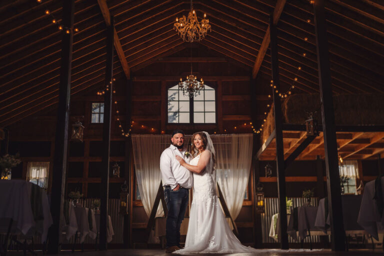 Creative night portrait of a bride and groom inside the string lit Mason Jar Gathering Barn
