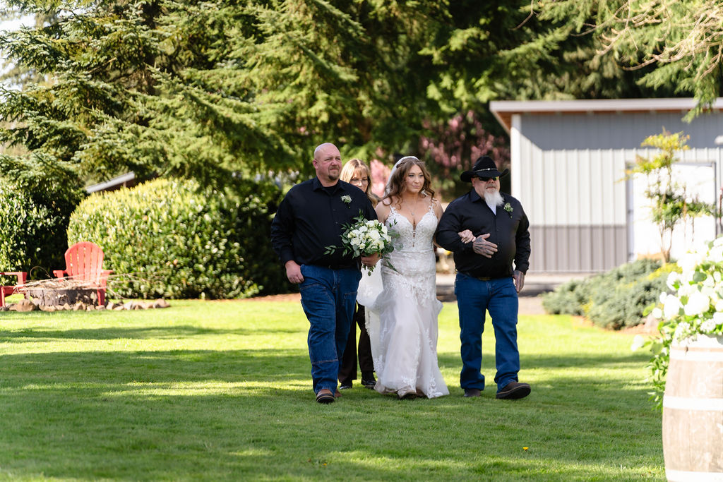 Bride walking down the aisle at a Mason Jar Gathering Barn wedding in Onalaska, Washington