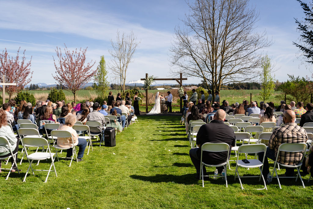 Wedding ceremony among the cedars at the Mason Jar Gathering Barn in Onalaska, Washington