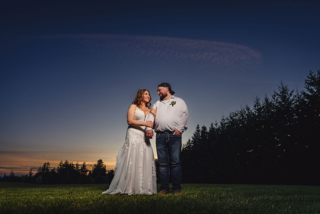 Bride and groom creative twilight portrait at the Mason Jar Gathering Barn at dusk