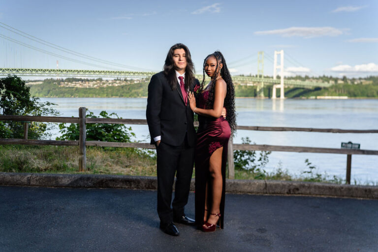 South Kitsap prom couple in burgundy and black formalwear standing together at the Tacoma Narrows Bridge viewpoint