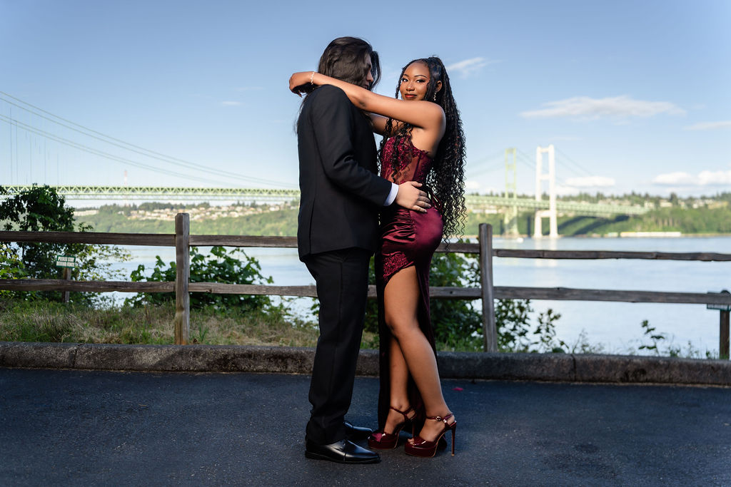 Prom couple embracing and smiling at the Tacoma Narrows Bridge overlook, Gig Harbor and Kitsap prom photography