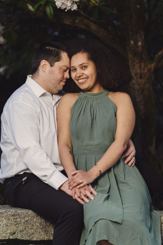 RJ and Maya standing together for a classic engagement portrait at Point Defiance Rose Garden in Tacoma