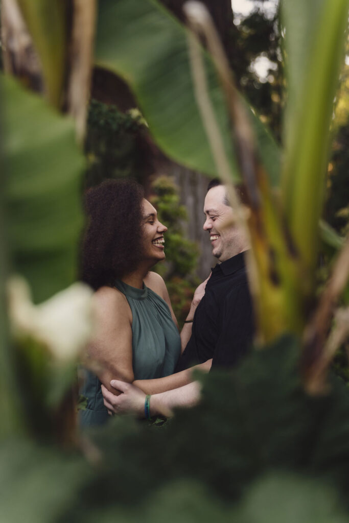 RJ and Maya framed by a garden structure during their engagement photos at Point Defiance Rose Garden